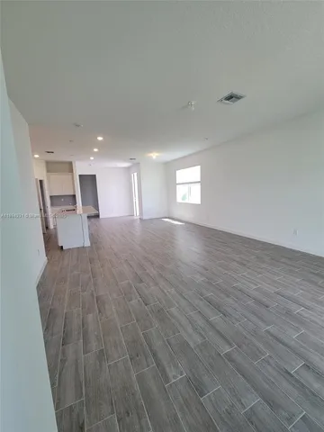 a view of a room with wooden floor and window