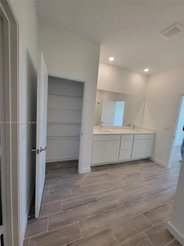 a view of walk in closet with empty racks