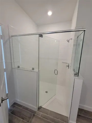 a bathroom with a glass shower door