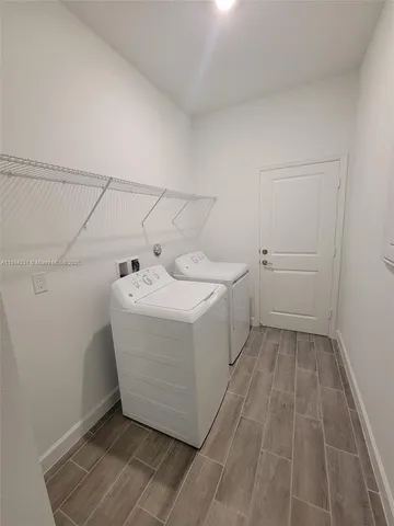a utility room with a sink dryer and washer