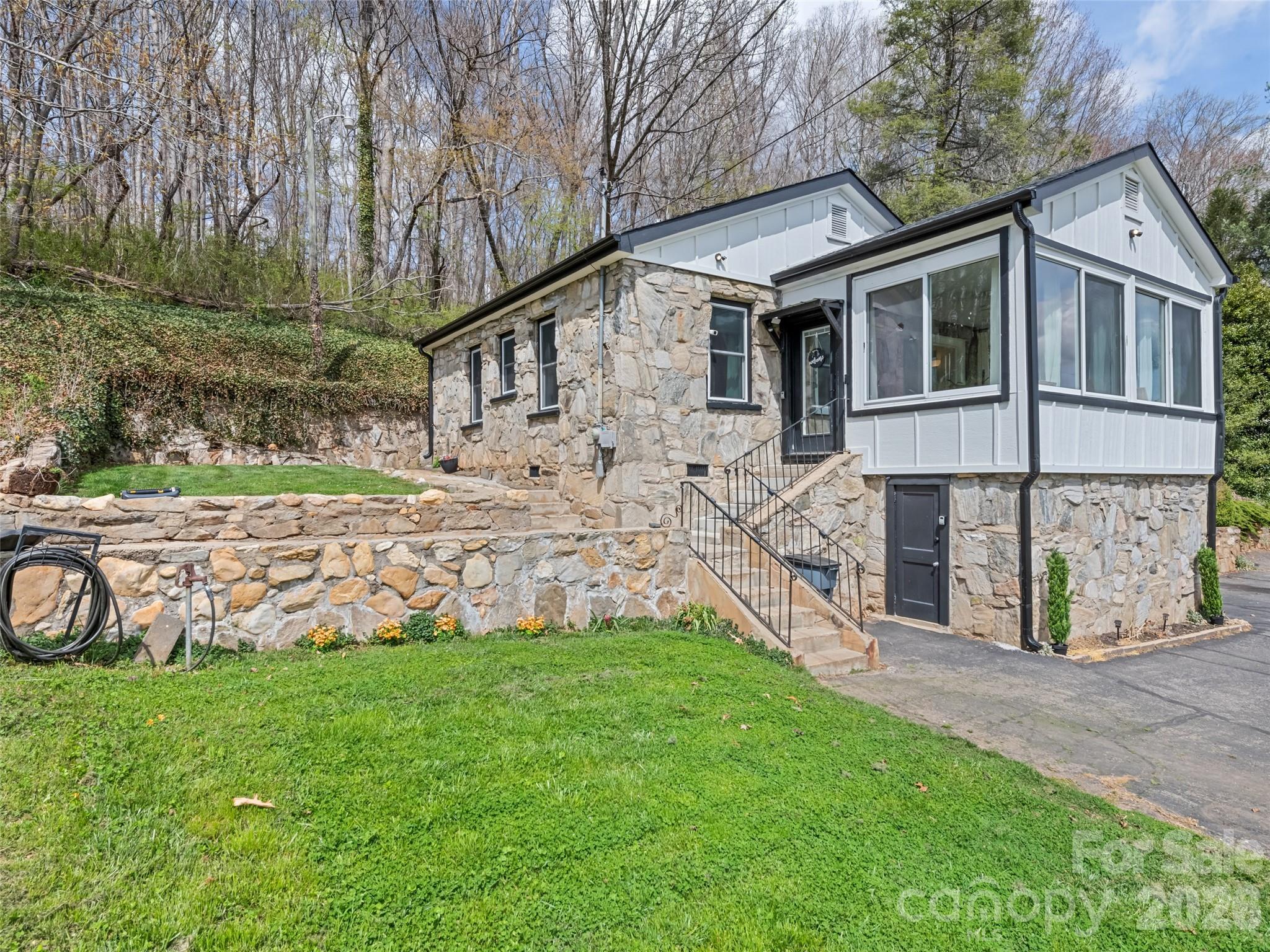 a view of a house with a yard and sitting area