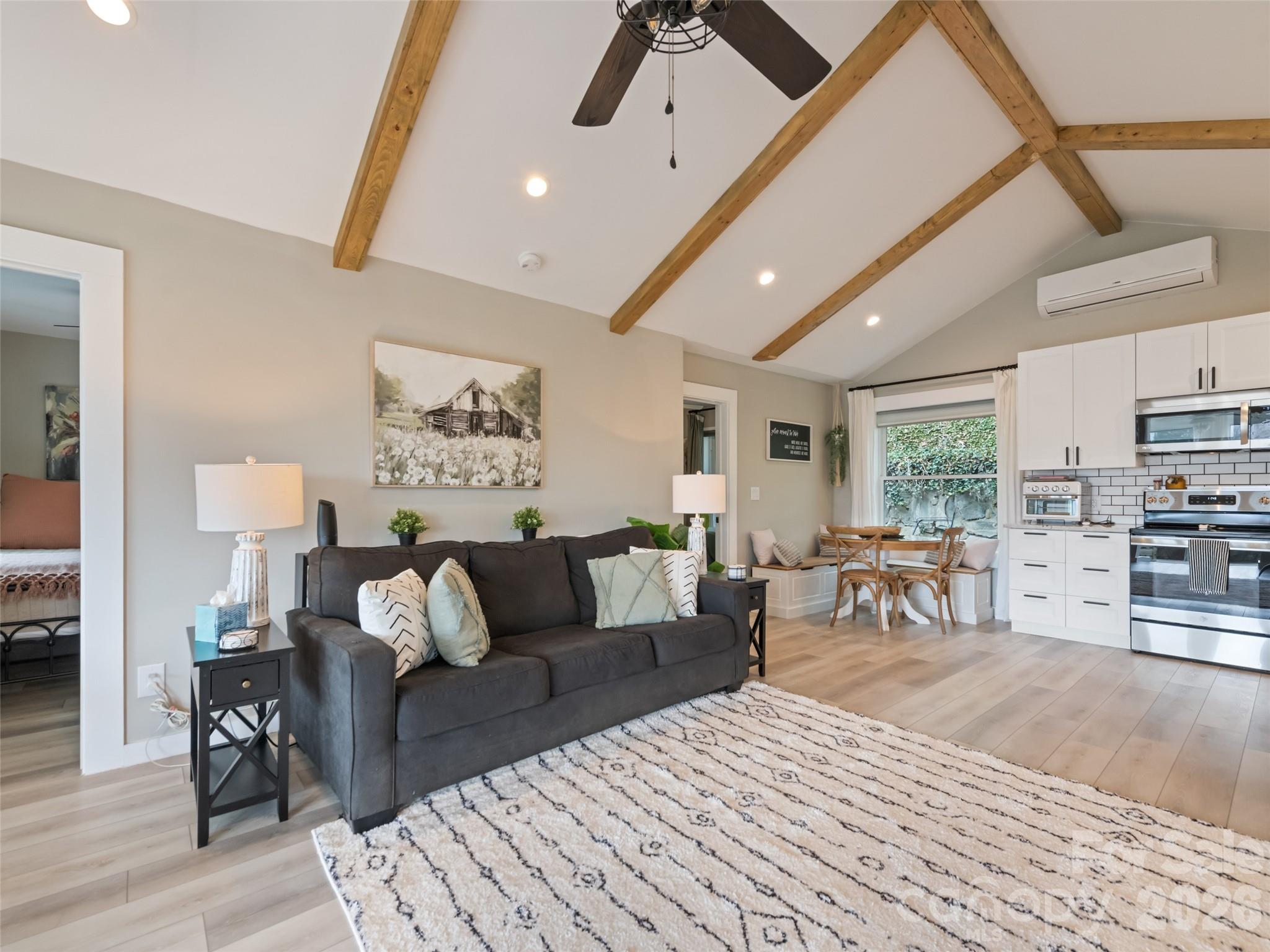 659 Golf Course Road Waynesville, NC 28786 - Photo 11 of 34 a living room with furniture and wooden floor