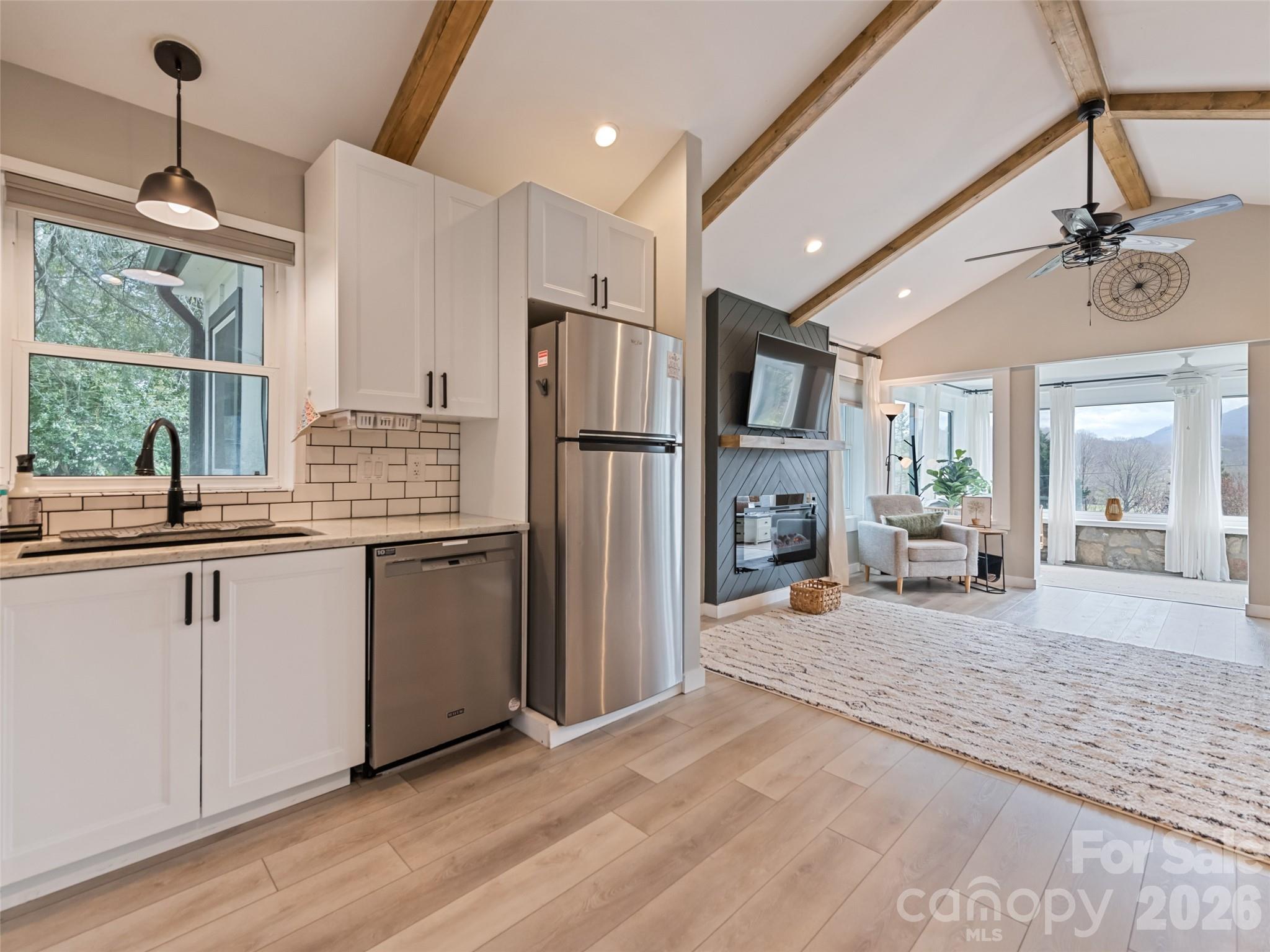 659 Golf Course Road Waynesville, NC 28786 - Photo 18 of 34 a kitchen with stainless steel appliances granite countertop a refrigerator and a sink