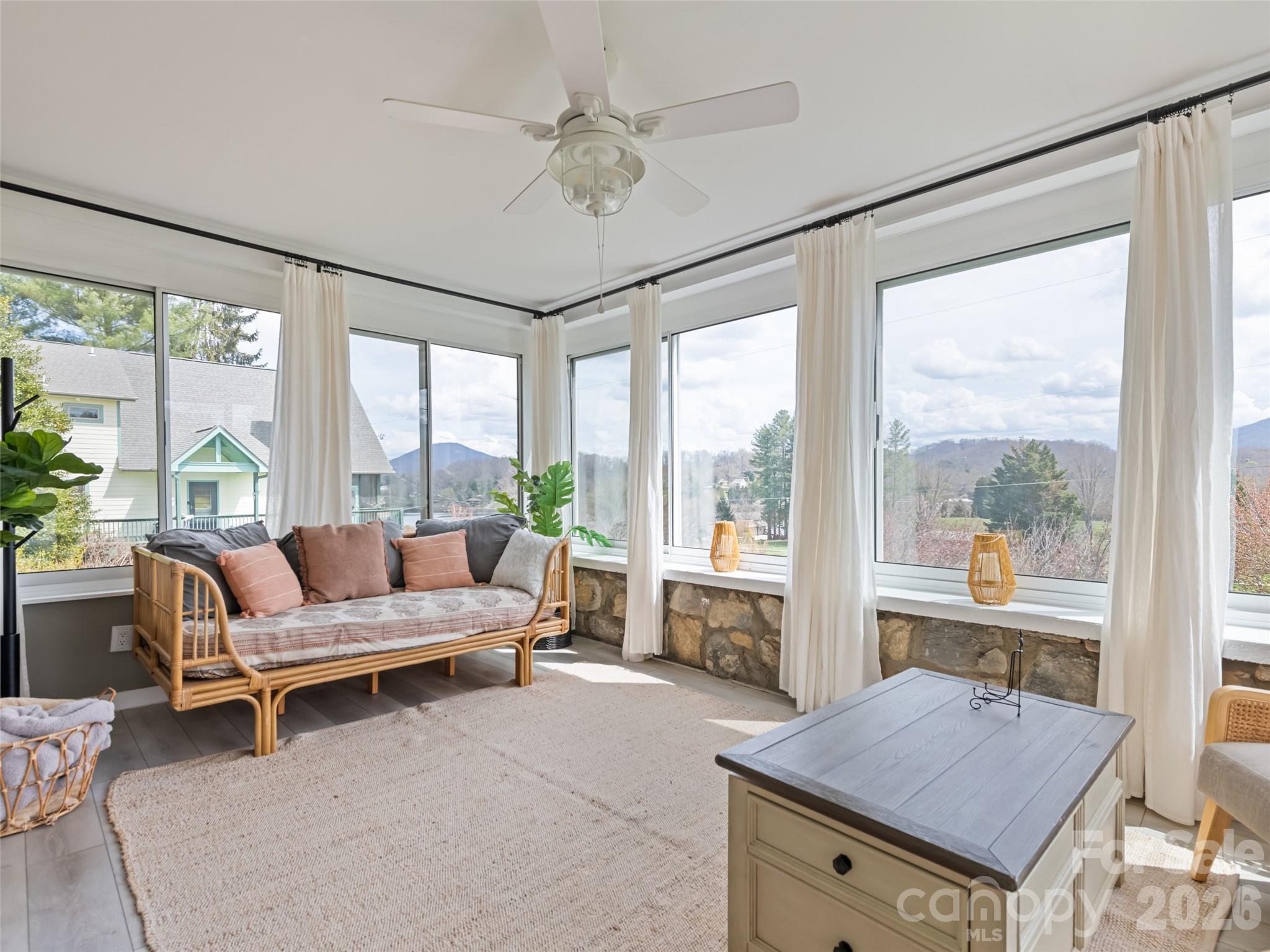 659 Golf Course Road Waynesville, NC 28786 - Photo 20 of 34 a living room with furniture and a floor to ceiling window