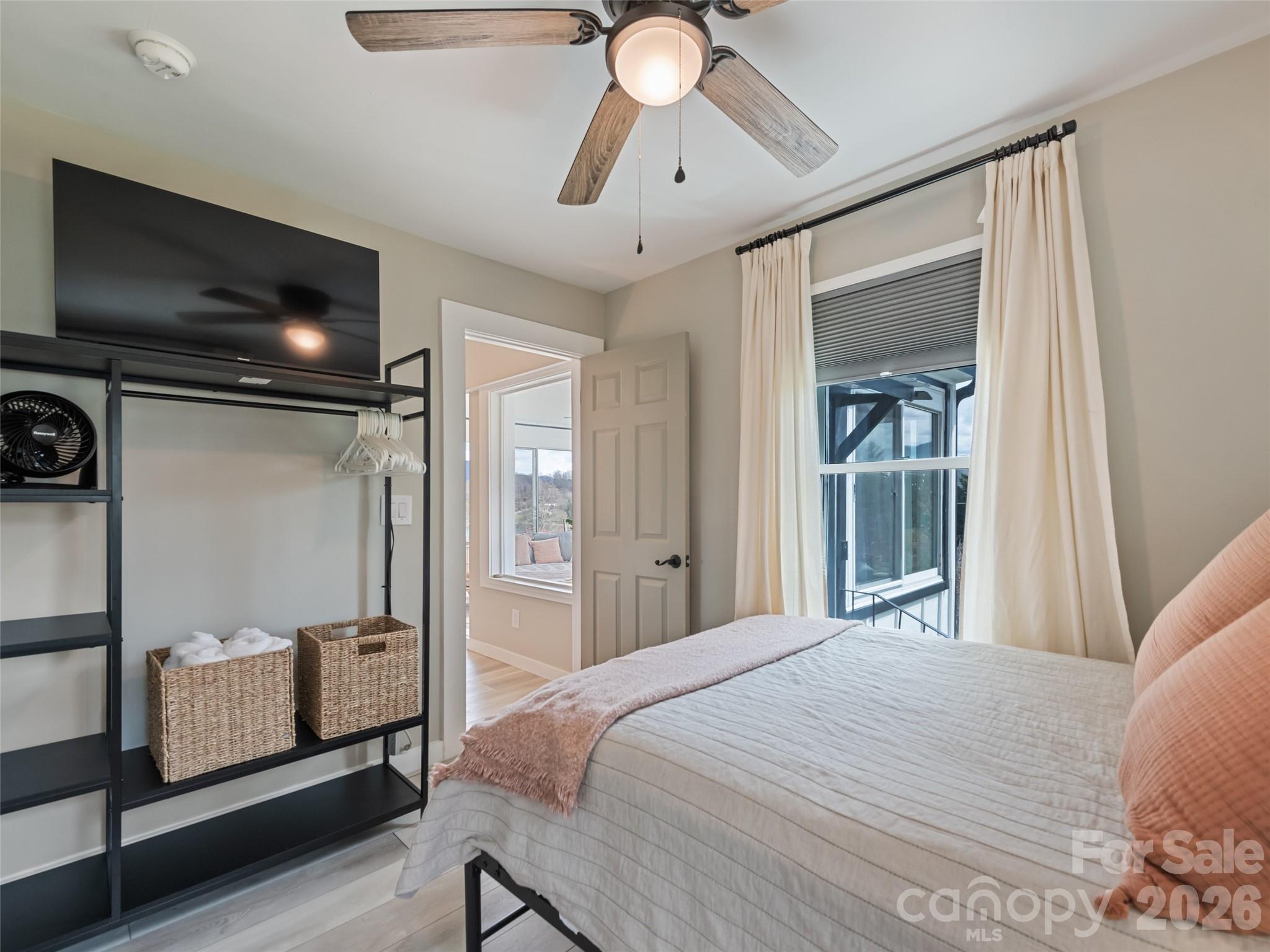659 Golf Course Road Waynesville, NC 28786 - Photo 23 of 34 a bedroom with a bed and a flat screen tv
