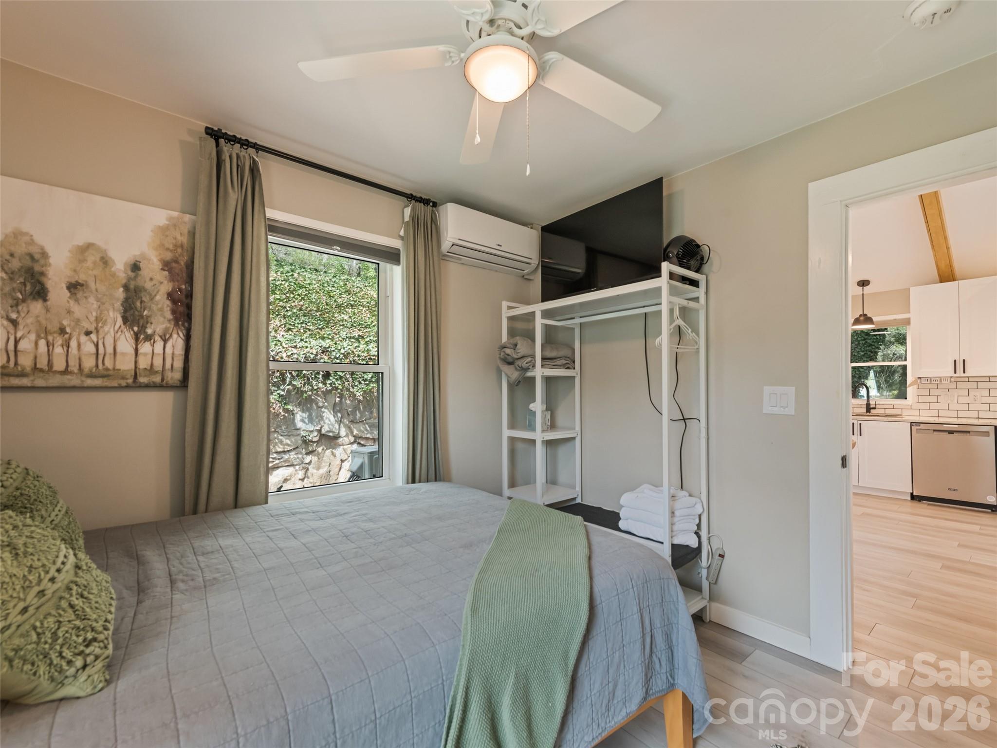 659 Golf Course Road Waynesville, NC 28786 - Photo 26 of 34 a bedroom with a bed and a chandelier
