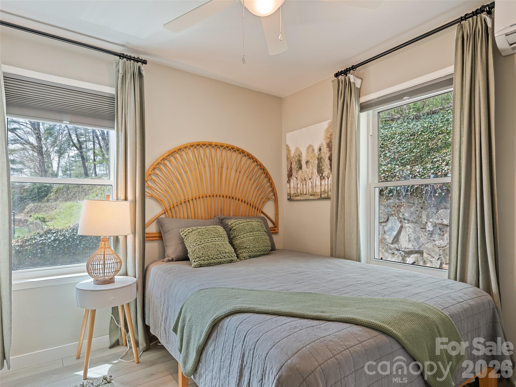 659 Golf Course Road Waynesville, NC 28786 - Photo 27 of 34 a bedroom with a large bed and a window