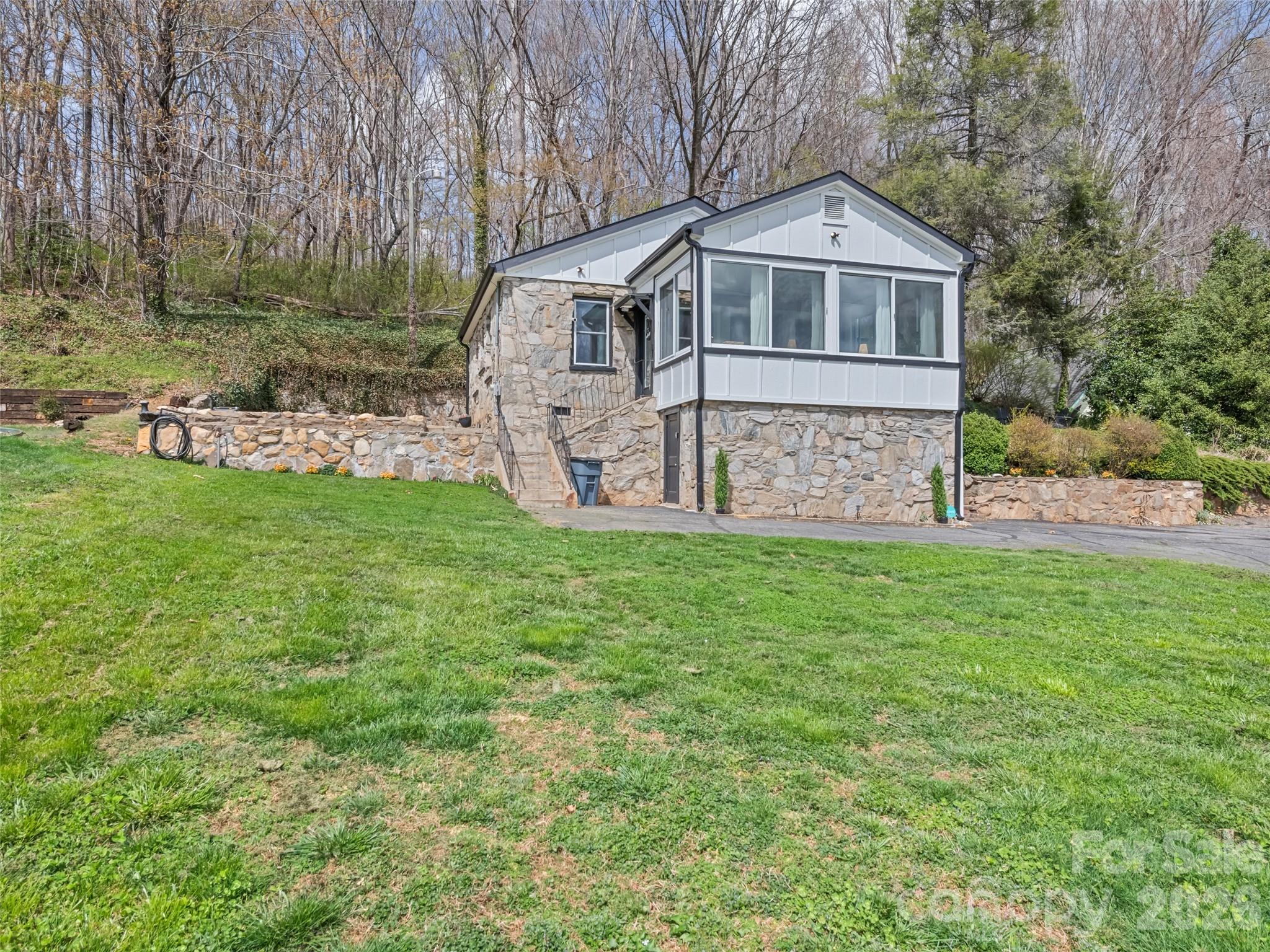 659 Golf Course Road Waynesville, NC 28786 - Photo 31 of 34 a front view of a house with garden