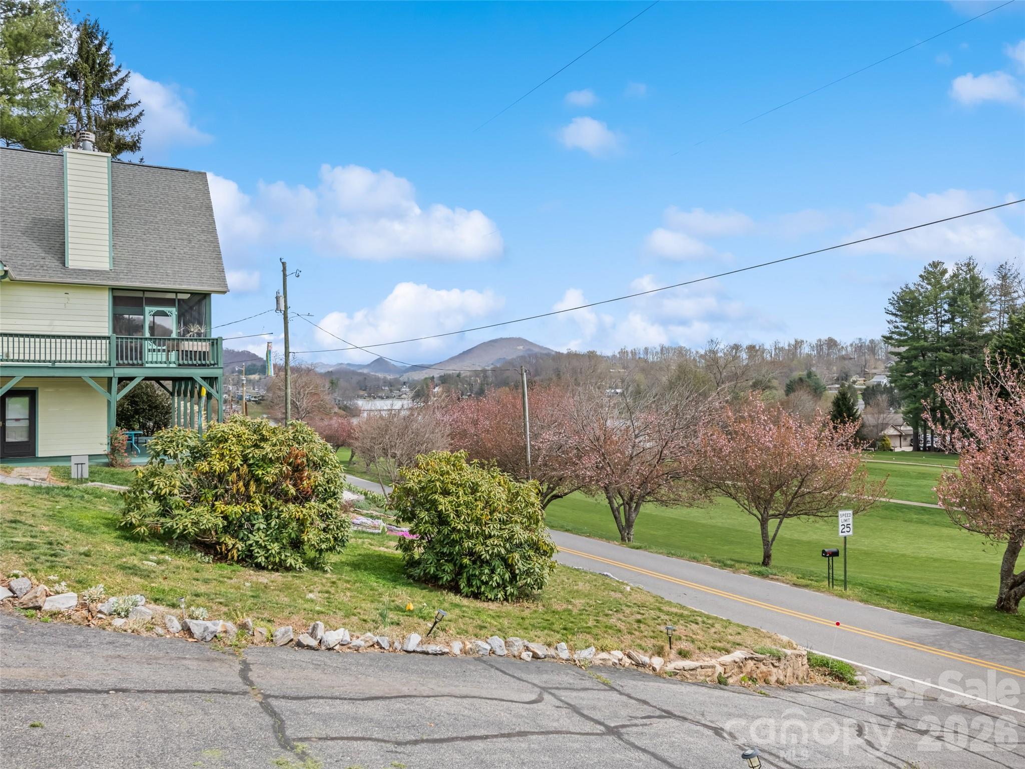 659 Golf Course Road Waynesville, NC 28786 - Photo 33 of 34 a view of a garden with a building in the background