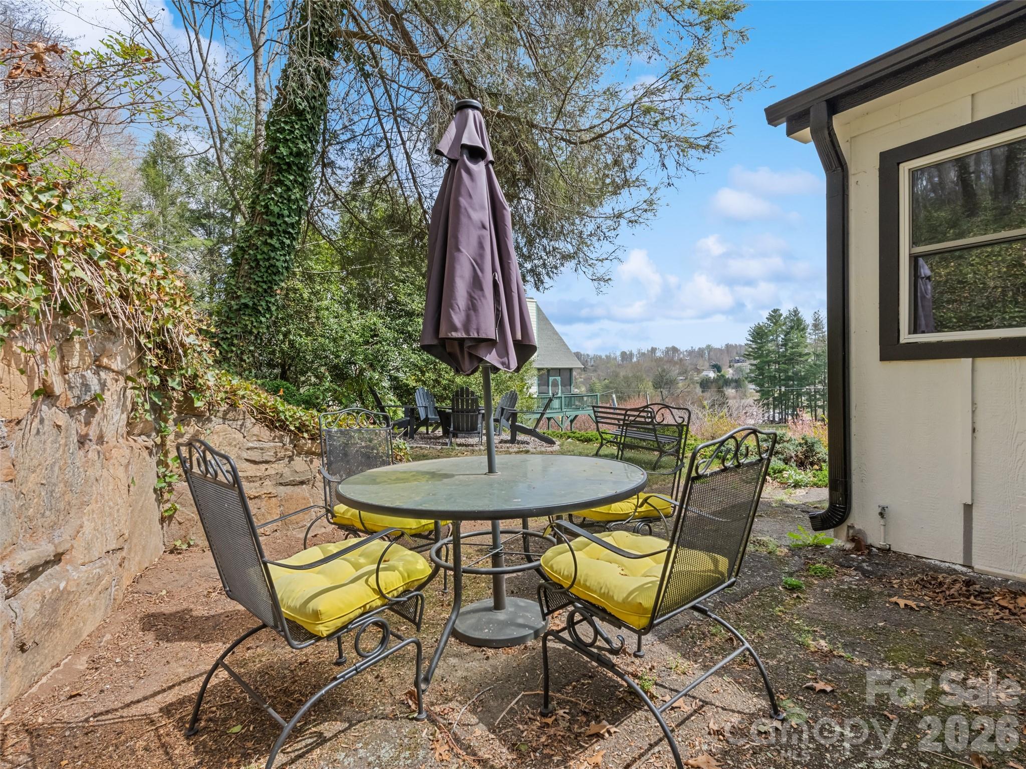 659 Golf Course Road Waynesville, NC 28786 - Photo 6 of 34 a view of a chairs and table in patio