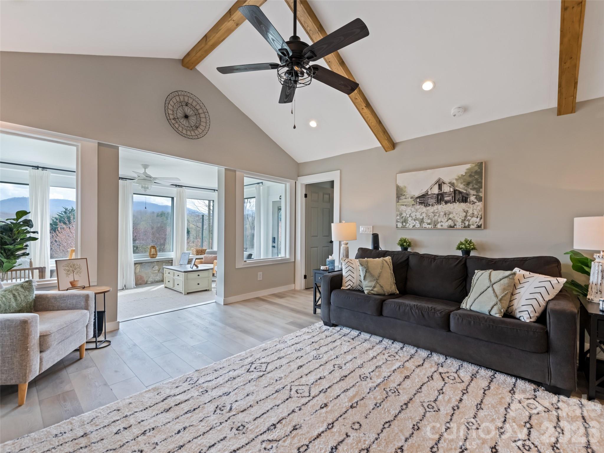 659 Golf Course Road Waynesville, NC 28786 - Photo 10 of 34 a living room with furniture and a large window