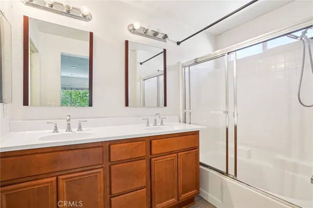 a bathroom with a double vanity sink mirror and double