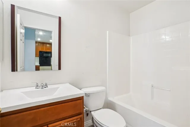 a bathroom with a sink toilet vanity and shower