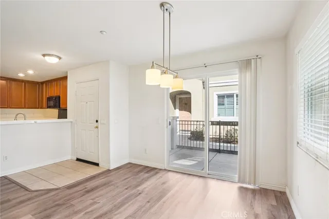 a view of a kitchen with wooden floor and a window