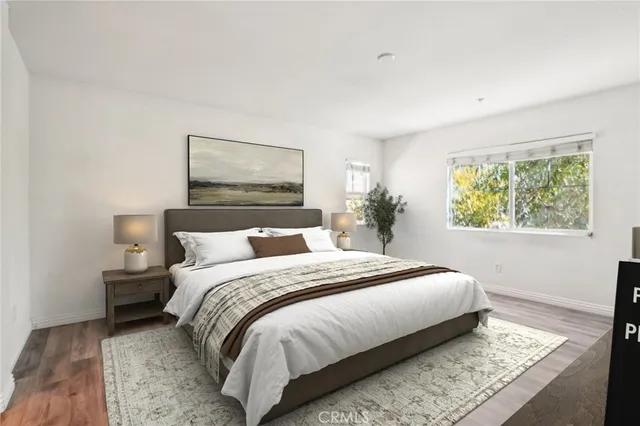 a bedroom with a bed and a painting on the wall