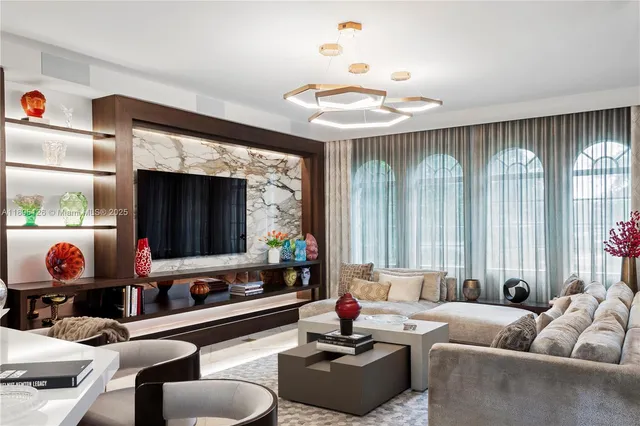 an empty room with furniture and a chandelier