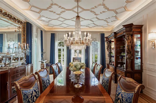 a living room with furniture chandelier and a large window