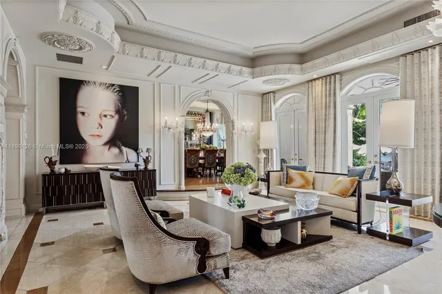 a living room with patio furniture and a chandelier