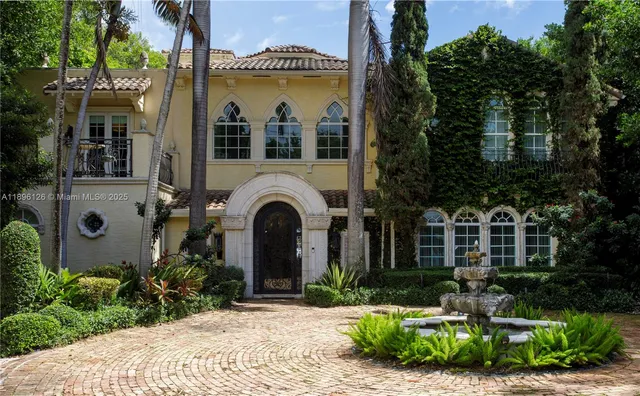 a view of a white house with swimming pool and sitting area