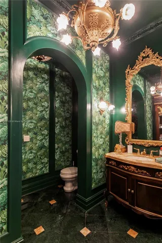 a bedroom with a large bed and a chandelier