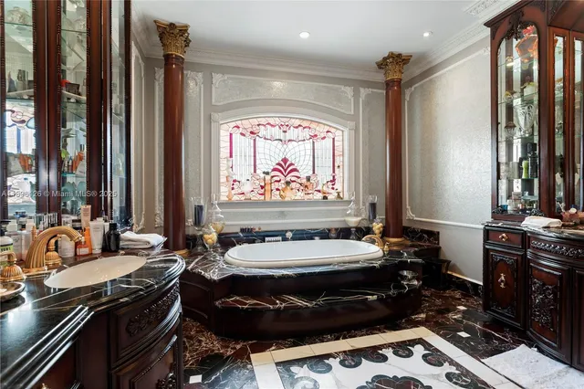 a bathroom with a granite countertop tub and a large window