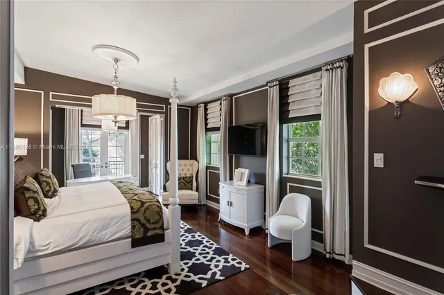 a room with a large window and chairs