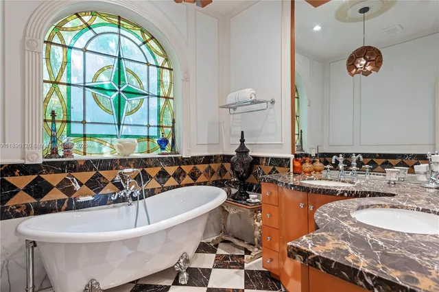 a front view of a house with swimming pool and sitting area