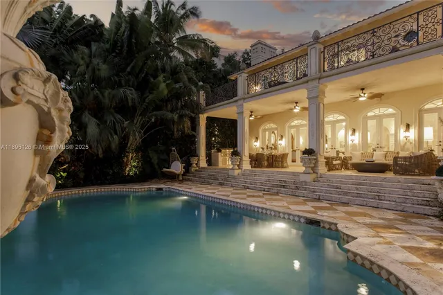a front view of a house with swimming pool and outdoor seating