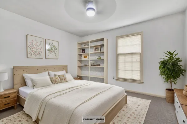 a bedroom with a large bed and a window