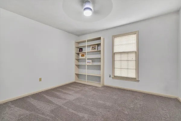 an empty room with a empty space and windows