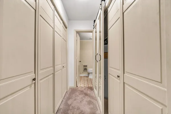 a white toilet sitting next to a shower