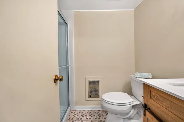 a bathroom with a sink a toilet and a mirror