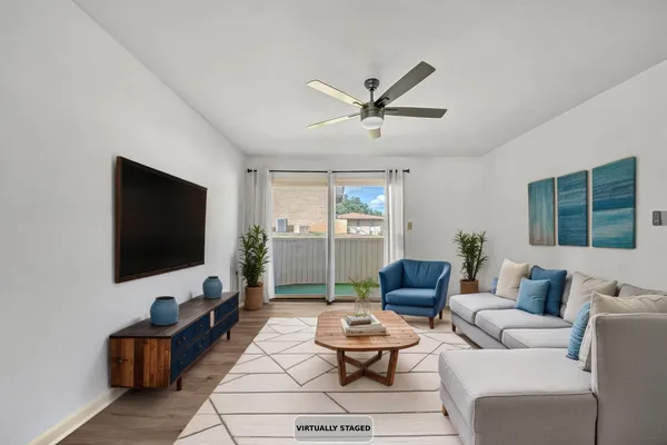 a living room with furniture and a flat screen tv