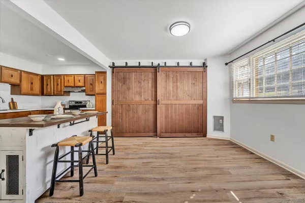 a kitchen with granite countertop a stove a sink and a refrigerator