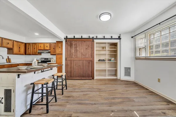 a kitchen with granite countertop a stove a sink and a refrigerator