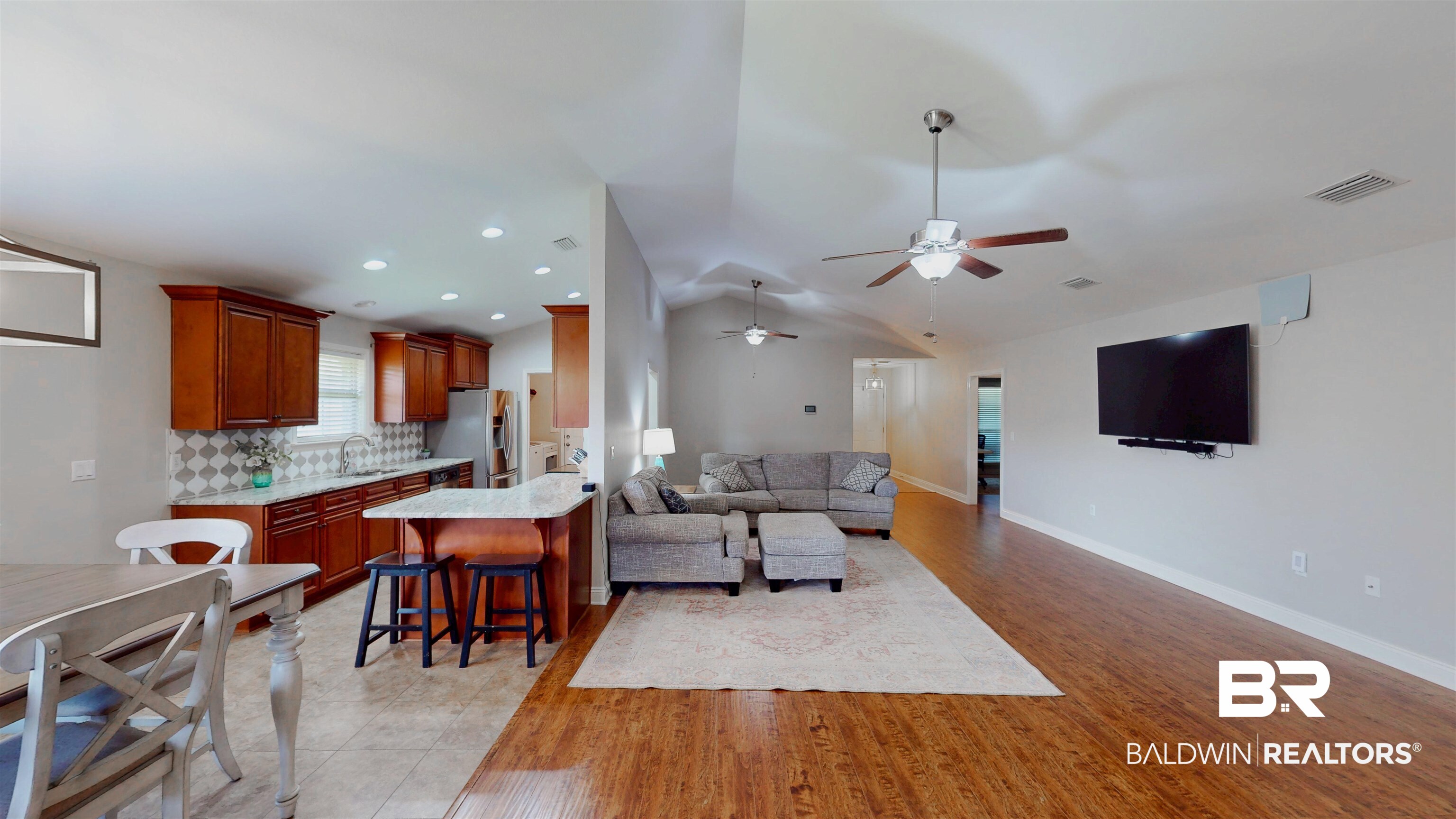 1704 Arcadia Drive Foley, AL 36535 - Photo 16 of 52 Living area with ceiling fan, lofted ceiling, and light wood finished floors