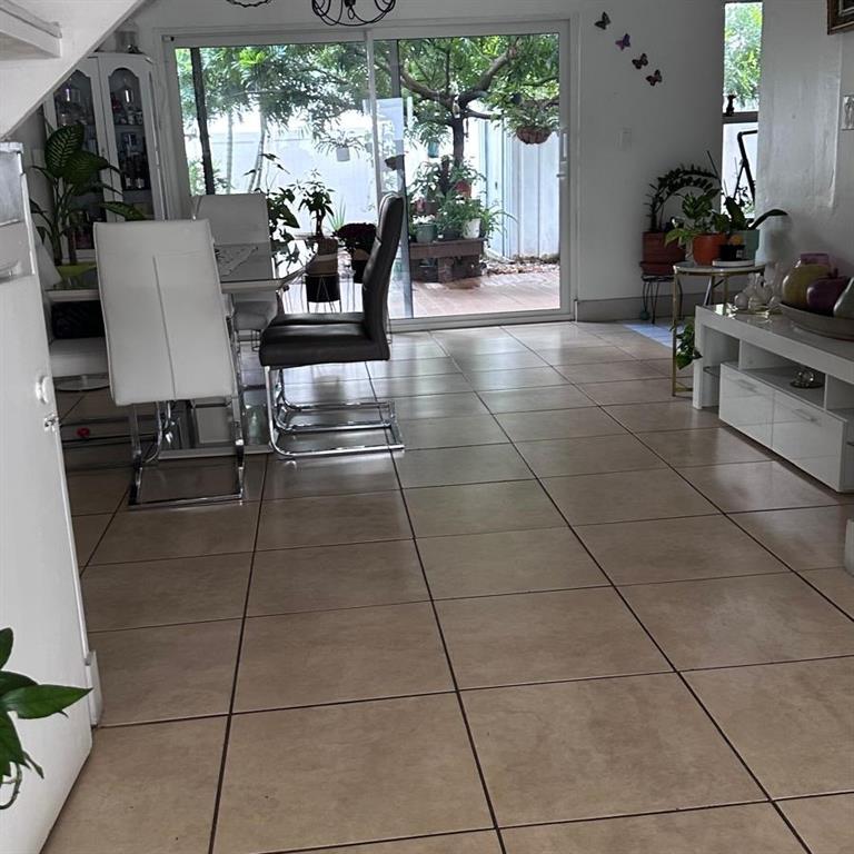 6728 Southwest 40th Street, Unit 6728 Fort Lauderdale, FL 33314 - Photo 4 of 13 a lobby with furniture and floor to ceiling window