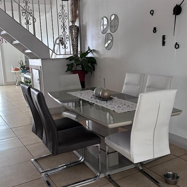 6728 Southwest 40th Street, Unit 6728 Fort Lauderdale, FL 33314 - Photo 7 of 13 a dining room with furniture and wooden floor