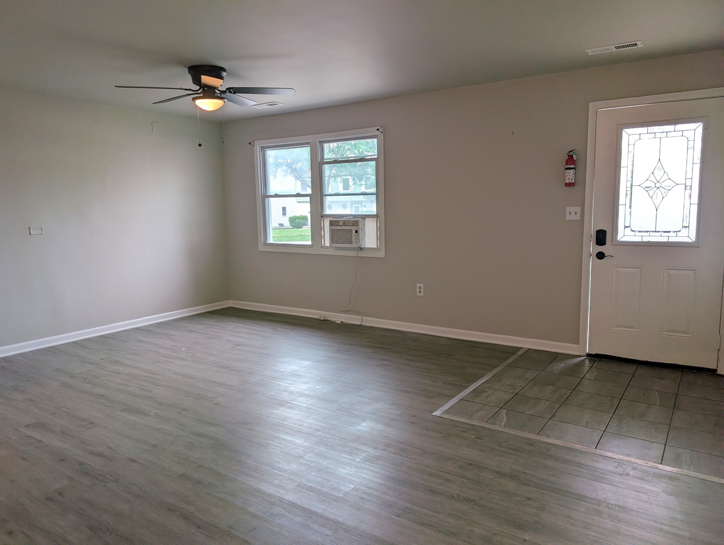 950 North Brainard Street Naperville, IL 60563 - Photo 5 of 9 an empty room with wooden floor and windows
