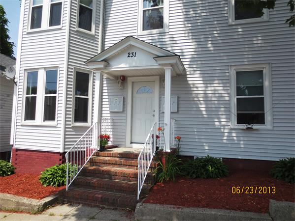231 Cato Street Woonsocket, RI 02895 - Photo 2 of 15 a view of a brick house with brick walls