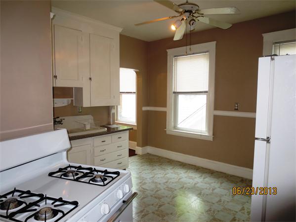 231 Cato Street Woonsocket, RI 02895 - Photo 4 of 15 a kitchen with a stove and a refrigerator