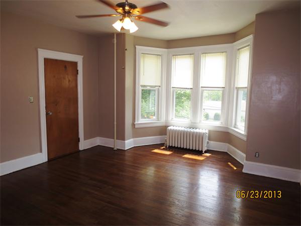 231 Cato Street Woonsocket, RI 02895 - Photo 5 of 15 a view of an empty room with wooden floor and a window