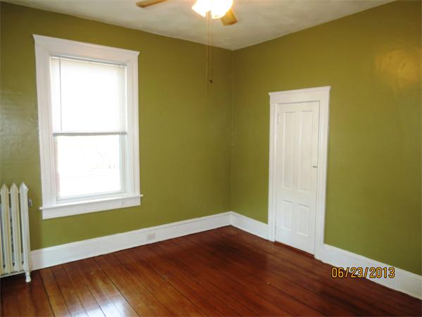 231 Cato Street Woonsocket, RI 02895 - Photo 6 of 15 an empty room with wooden floor and windows