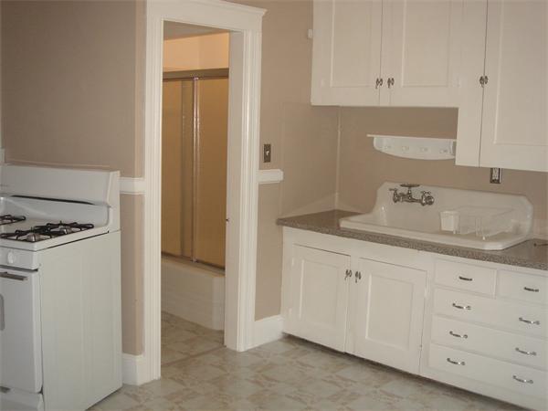 231 Cato Street Woonsocket, RI 02895 - Photo 8 of 15 a kitchen with granite countertop white cabinets and sink