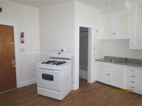 231 Cato Street Woonsocket, RI 02895 - Photo 10 of 15 a kitchen with granite countertop white cabinets and white appliances