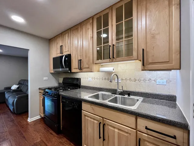 a kitchen that has a sink and a stove