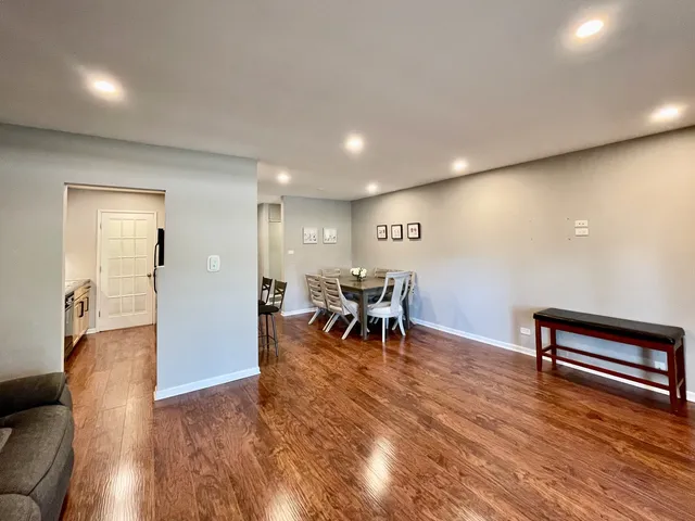 a view of a room with furniture and wooden floor
