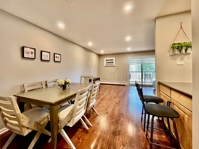 a view of a dining room with furniture and wooden floor