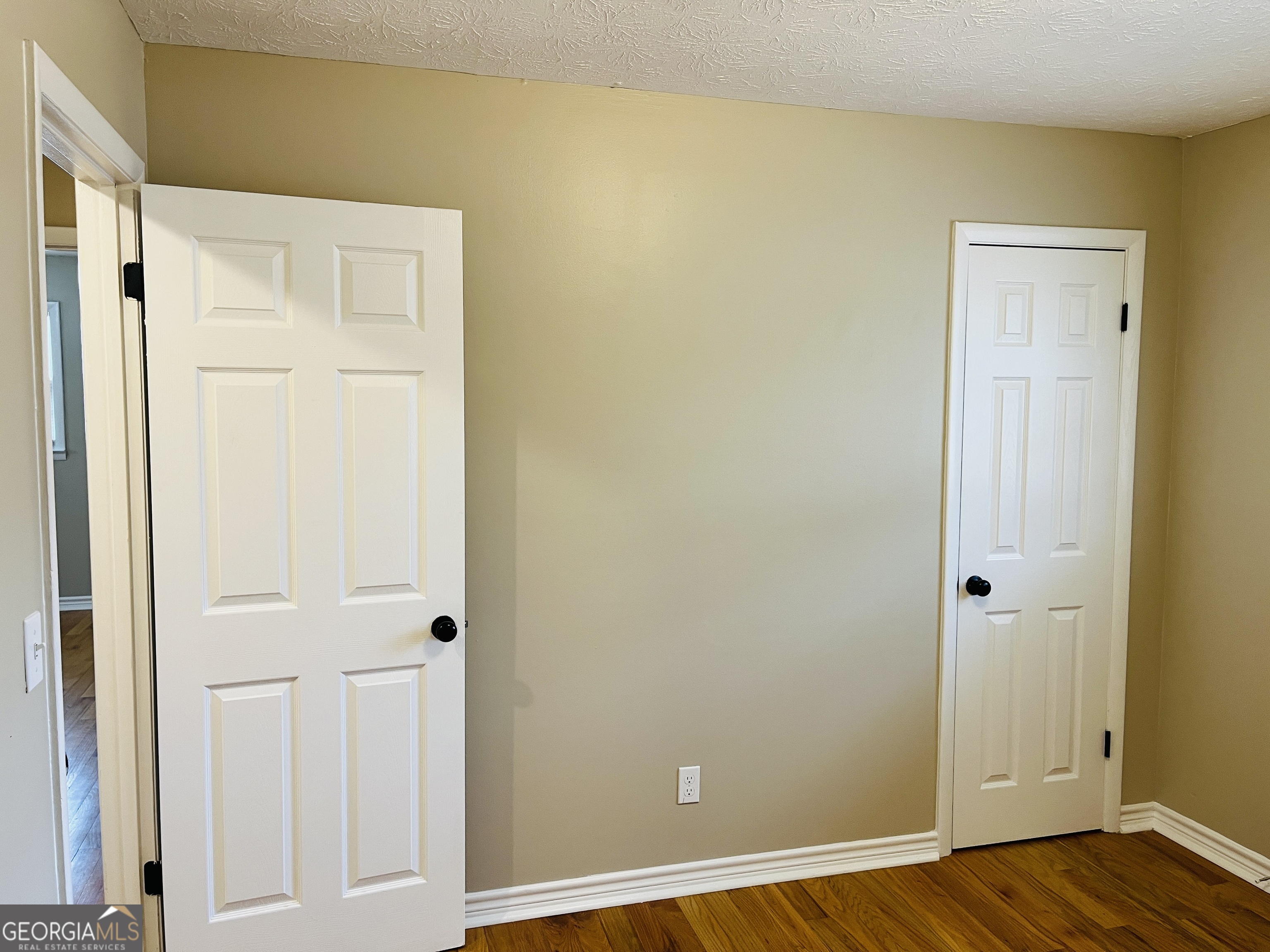 1085 Horsley Mill Road Carrollton, GA 30116 - Photo 15 of 26 an empty room with wooden floor and closet area