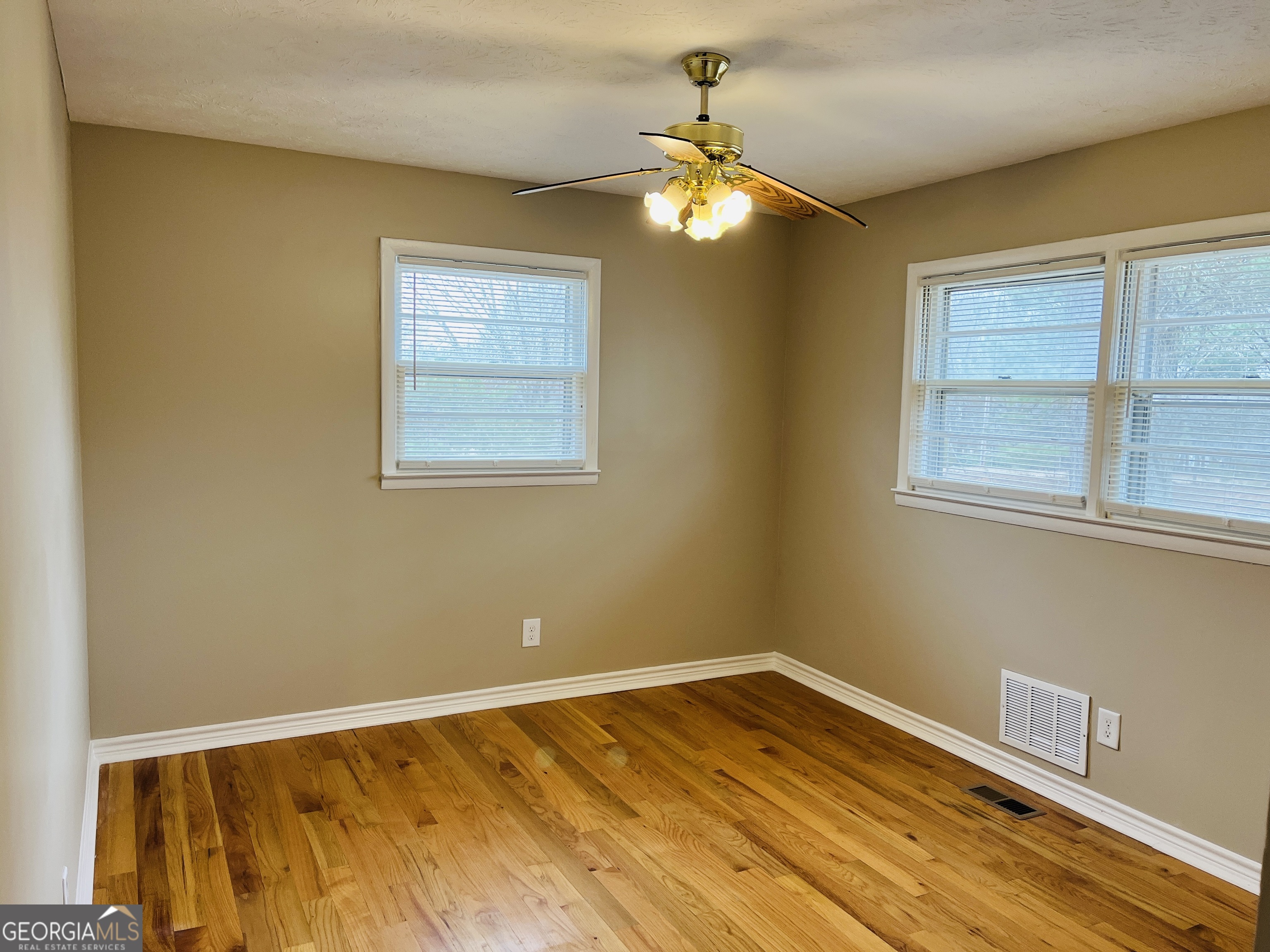 1085 Horsley Mill Road Carrollton, GA 30116 - Photo 17 of 26 a view of an empty room with wooden floor and a window